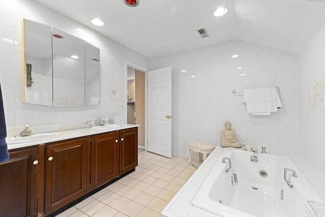 bathroom featuring tile walls, lofted ceiling, and tile patterned flooring