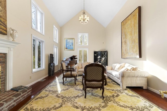 living area featuring high vaulted ceiling, dark hardwood / wood-style flooring, and an inviting chandelier