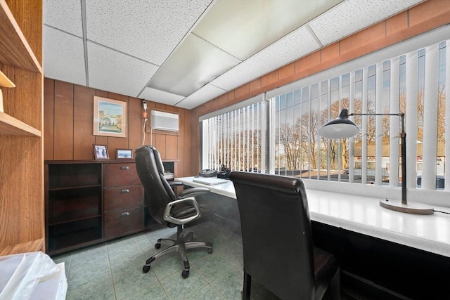 office area with a paneled ceiling and a wall unit AC