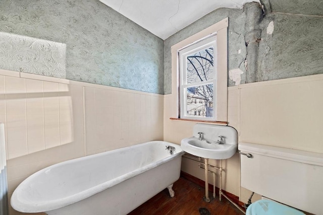 bathroom with sink, hardwood / wood-style floors, and a tub