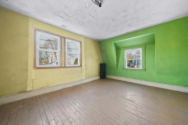 spare room with hardwood / wood-style floors and a wealth of natural light