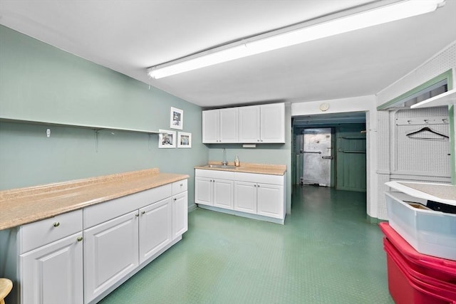 kitchen featuring sink and white cabinets