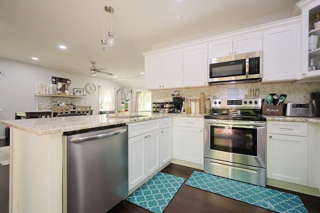 47 Leno Rd, Holland, MA 01521 - kitchen with appliances with stainless steel finishes, a sink, a peninsula, ceiling fan, and tasteful backsplash