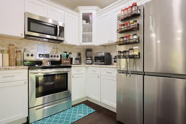47 Leno Rd, Holland, MA 01521 - kitchen with stainless steel appliances, white cabinetry, decorative backsplash, dark wood finished floors, and glass insert cabinets