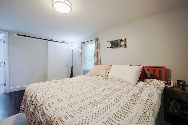 47 Leno Rd, Holland, MA 01521 - bedroom with wood finished floors, a barn door, and baseboards