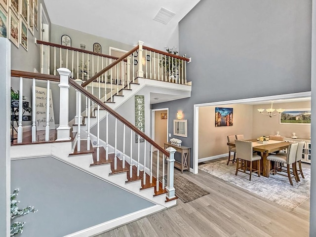 15 Stone Fence Dr, Derry, NH 03038 - stairs with a high ceiling, wood finished floors, and a chandelier