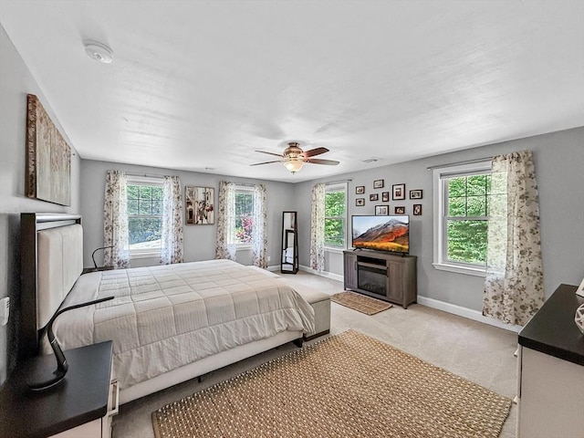 15 Stone Fence Dr, Derry, NH 03038 - bedroom featuring multiple windows, a glass covered fireplace, carpet flooring, and ceiling fan