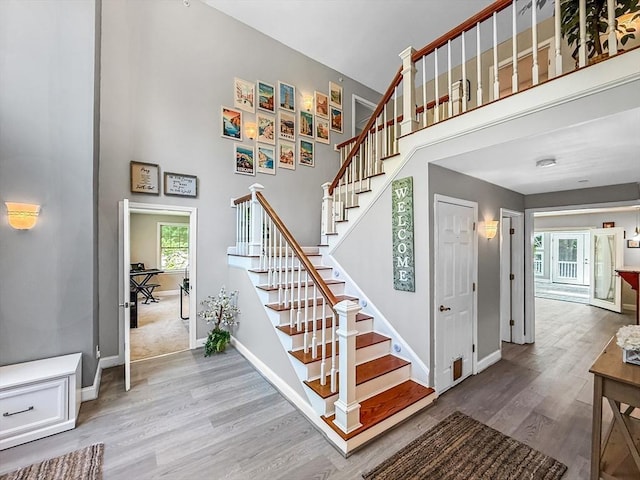 15 Stone Fence Dr, Derry, NH 03038 - stairway featuring wood finished floors and a towering ceiling