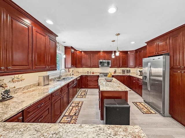 15 Stone Fence Dr, Derry, NH 03038 - kitchen featuring appliances with stainless steel finishes, light stone counters, recessed lighting, decorative light fixtures, and light wood finished floors
