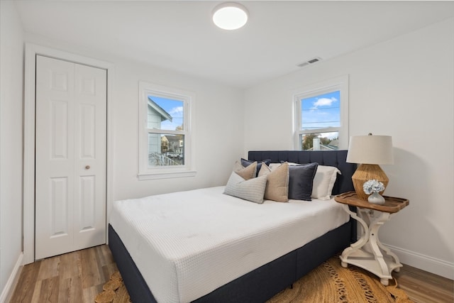 bedroom featuring hardwood / wood-style flooring and multiple windows