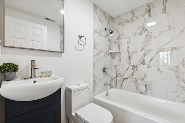 full bathroom featuring vanity, toilet, and tiled shower / bath