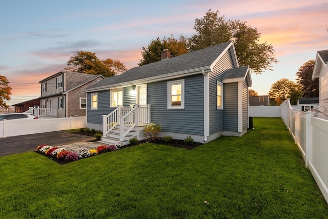 view of front of property with a patio area and a yard