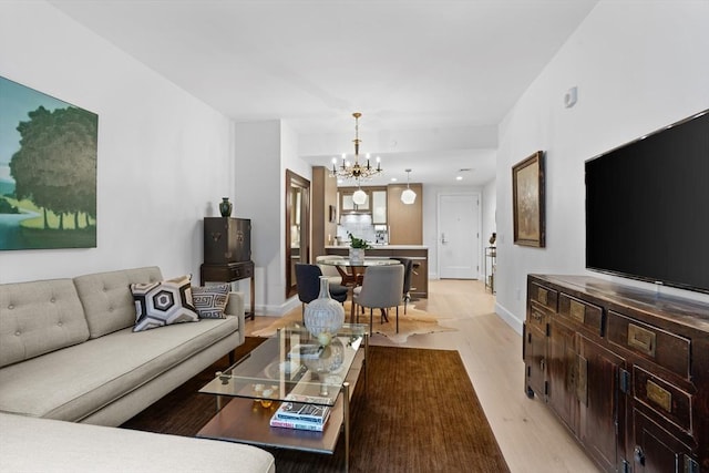 100 Lovejoy Wharf Unit 5N, Boston, MA 02114 - living area featuring light wood-style flooring, baseboards, and a notable chandelier