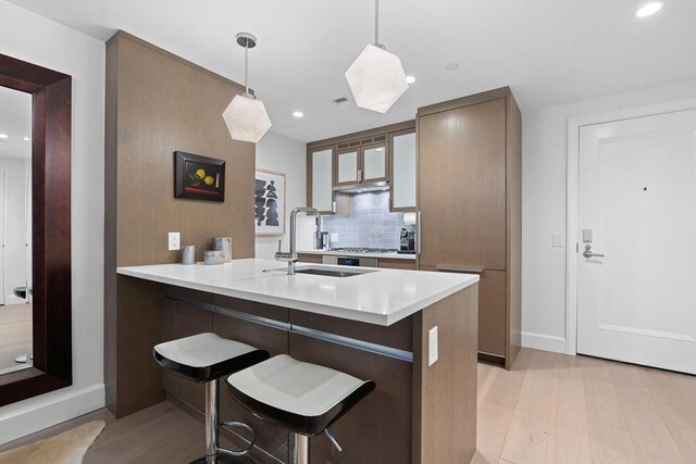 100 Lovejoy Wharf Unit 5N, Boston, MA 02114 - kitchen with light wood-style flooring, recessed lighting, and a sink