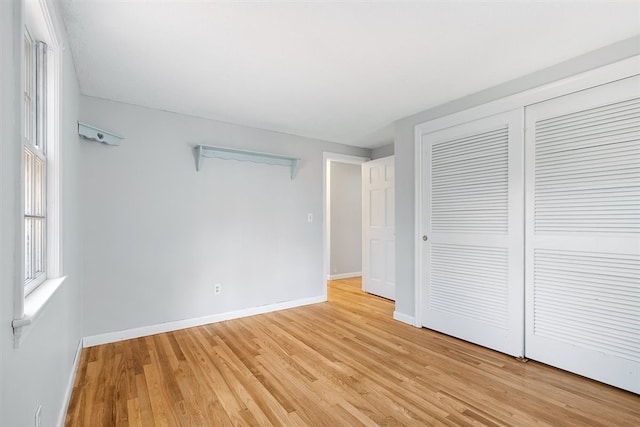 unfurnished bedroom featuring a closet and light hardwood / wood-style flooring