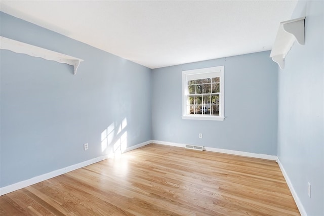 empty room with light hardwood / wood-style floors