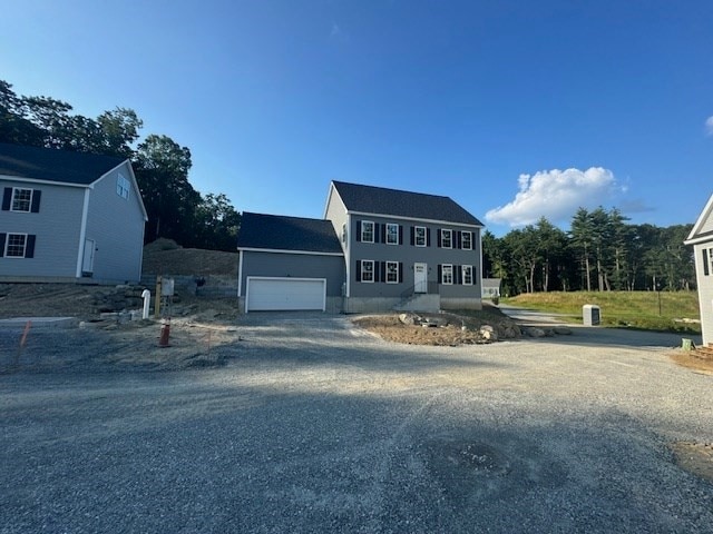 colonial home with driveway and an attached garage