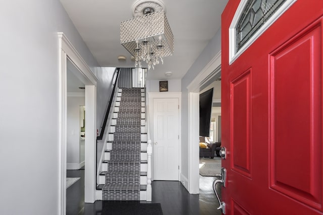 entryway featuring a chandelier and dark hardwood / wood-style flooring