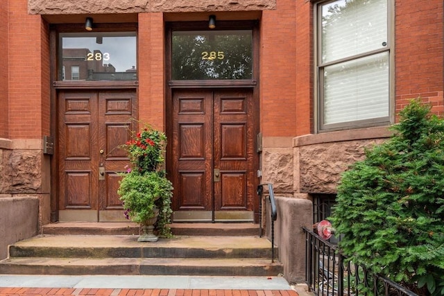 property entrance with brick siding