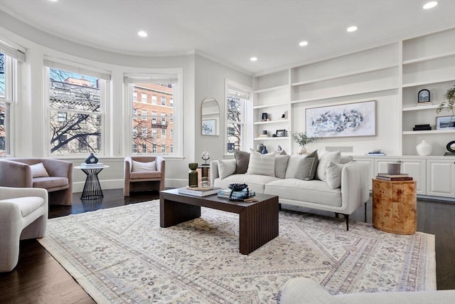 living area with recessed lighting, wood finished floors, and ornamental molding