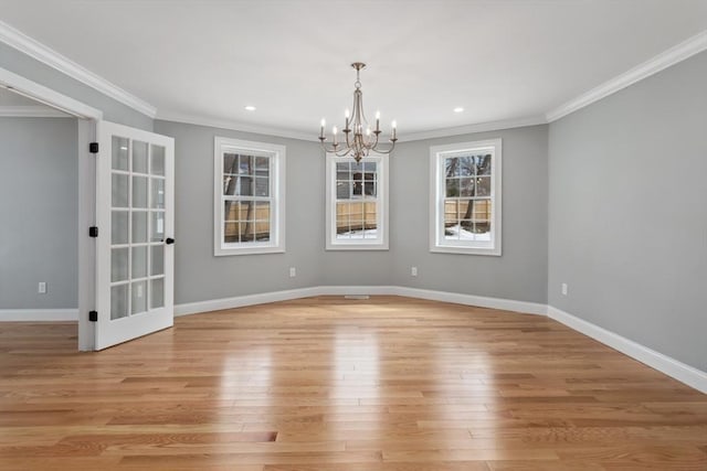 unfurnished room featuring light wood finished floors, baseboards, and crown molding