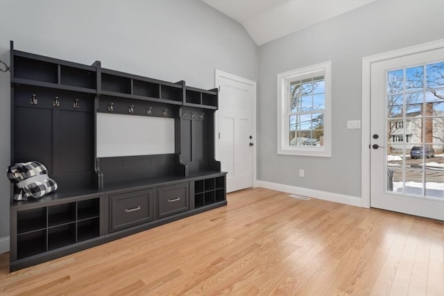 mudroom featuring lofted ceiling, visible vents, light wood-style flooring, and baseboards