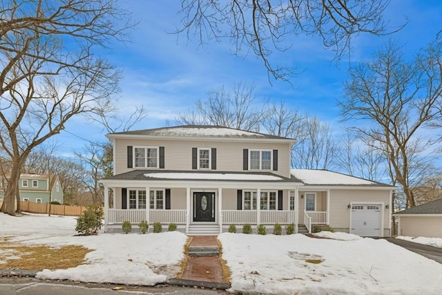 view of front of home featuring a porch, fence, and an attached garage