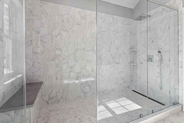 full bathroom with a marble finish shower