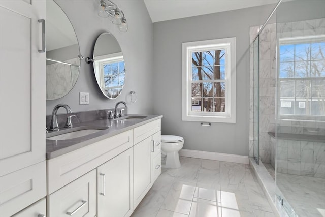 bathroom with a stall shower and a sink