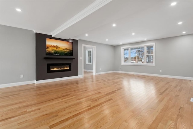 unfurnished living room with light wood-style floors, baseboards, and recessed lighting