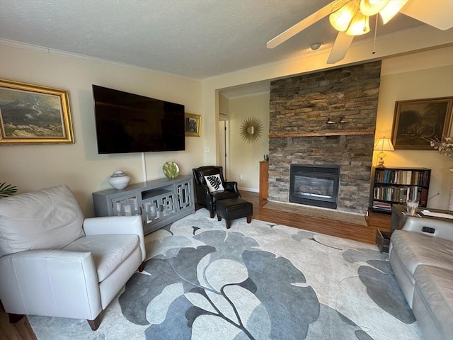 21 Deer Run, Brookfield, MA 01506 - living room with wood finished floors, a fireplace, a ceiling fan, crown molding, and a textured ceiling