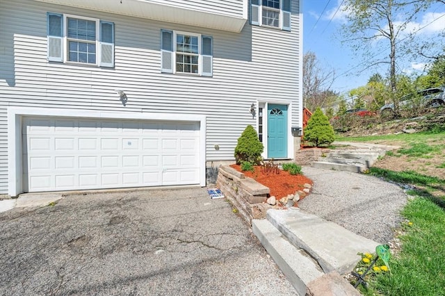 exterior space featuring an attached garage and aphalt driveway