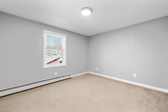 carpeted empty room featuring baseboards and a baseboard heating unit