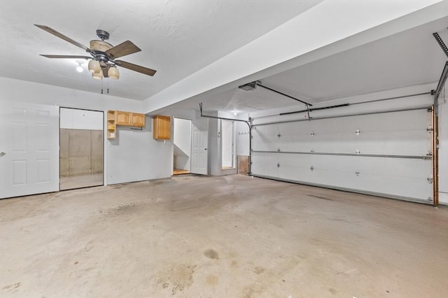 garage featuring a ceiling fan and a garage door opener