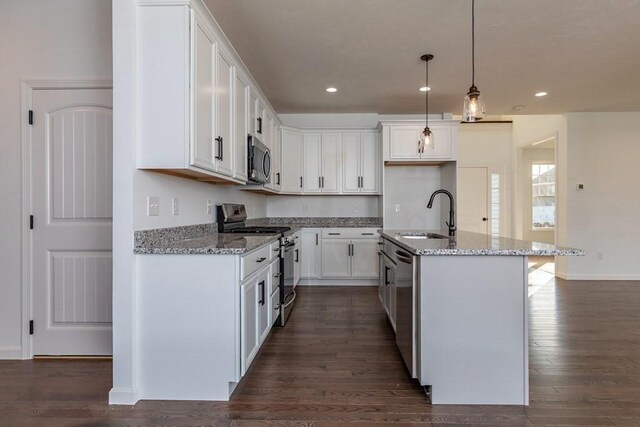 kitchen featuring sink, white cabinets, a center island with sink, and appliances with stainless steel finishes