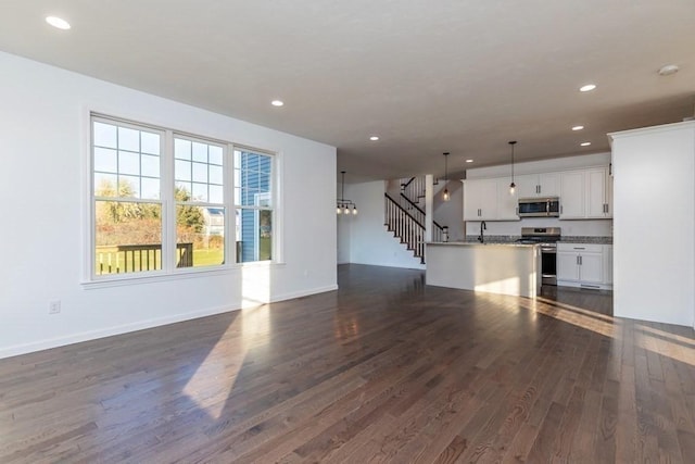 unfurnished living room featuring dark hardwood / wood-style floors