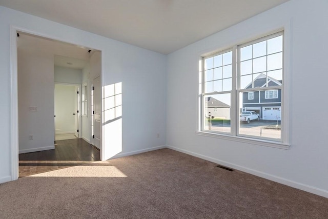 empty room with dark colored carpet