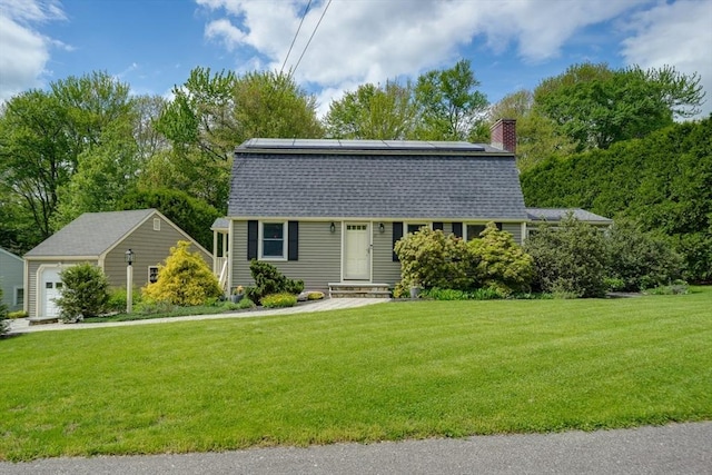 colonial inspired home featuring a gambrel roof, solar panels, and a front lawn