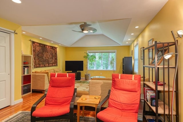 living area featuring wood finished floors, ceiling fan, recessed lighting, and vaulted ceiling
