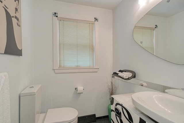half bathroom featuring toilet and vanity