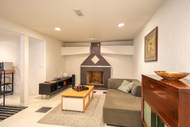 living area with a fireplace, recessed lighting, and tile patterned floors