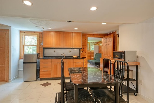 dining room with baseboards, recessed lighting, and light tile patterned floors