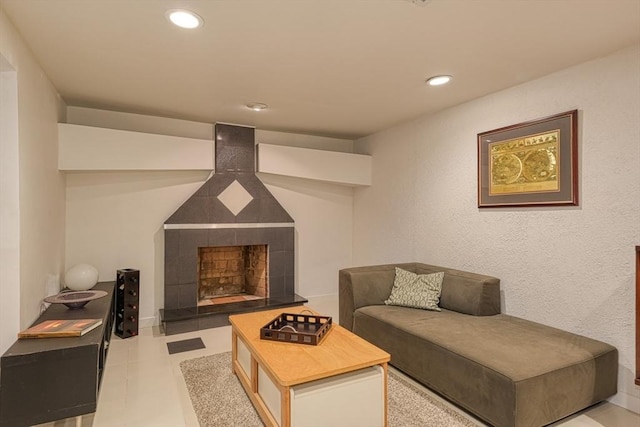 living area featuring a tiled fireplace and recessed lighting