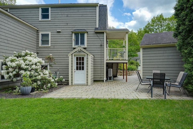 back of property with a patio and a yard