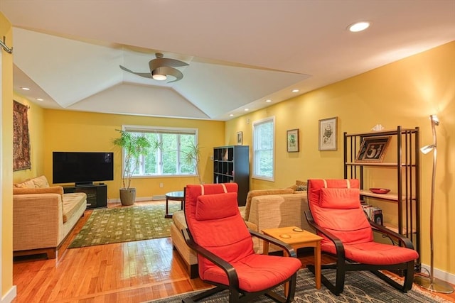 living room with light wood-type flooring, baseboards, ceiling fan, recessed lighting, and vaulted ceiling