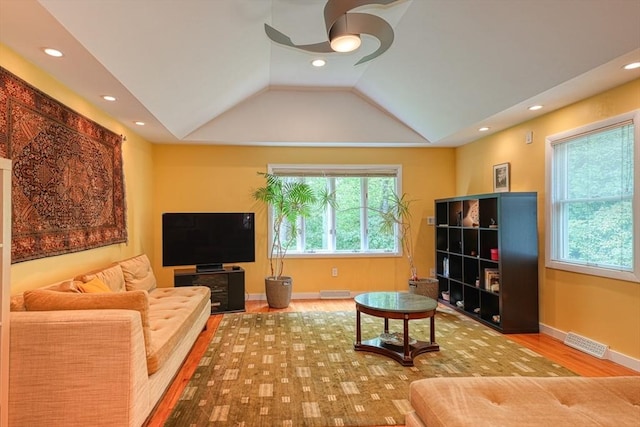 living area featuring a ceiling fan, healthy amount of natural light, wood finished floors, recessed lighting, and lofted ceiling