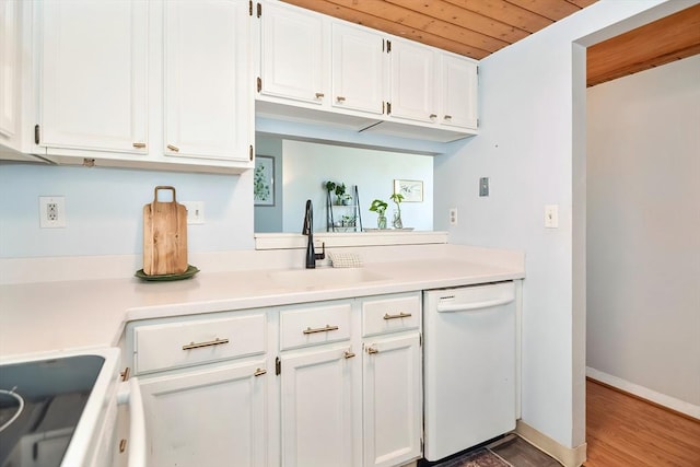 kitchen with baseboards, white cabinets, white dishwasher, and light countertops