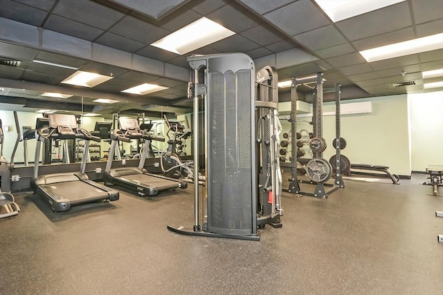 exercise room with visible vents and a paneled ceiling