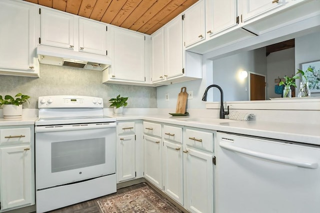 kitchen with white appliances, white cabinets, under cabinet range hood, and a sink