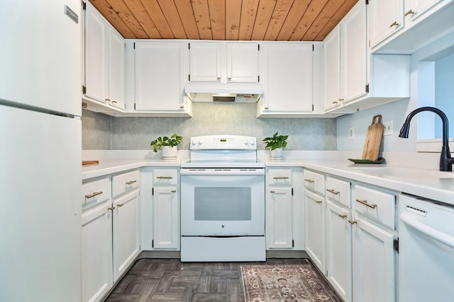 kitchen with under cabinet range hood, light countertops, white cabinets, white appliances, and a sink